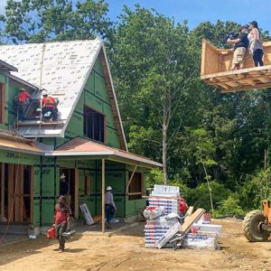 Director of Photography, John Carboni and his producer shooting from a custom built camera platform mounted at the end of telescopic forklift.