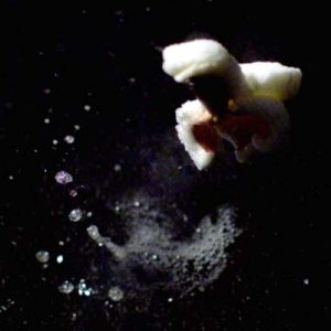 Extreme slow-motion playback of a popcorn burst, technical production by Impact Studios.