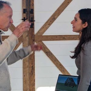 Host Kevin Durkin delivers an enthusiastic architectural lesson on-site, engaging in a detailed technical discussion with Kathryn Crowley regarding the historical significance and restoration potential of the property.