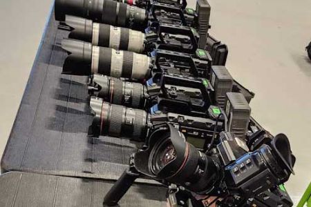 Table full of blackmagic video cameras with different lenses